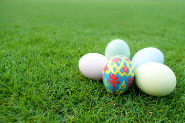 Fototapeta na wymiar Easter eggs on green lawn