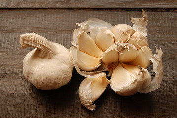 Cloves of garlic on dark wooden background - close-up