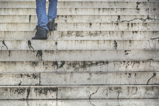 Man Walking Climb Up In Old Stairs