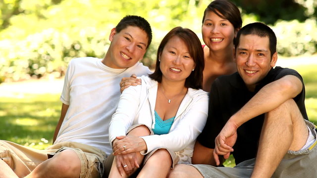 Portrait of Asian family in outdoor setting