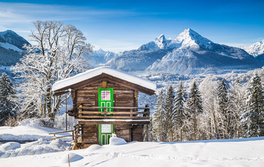 Winter wonderland in the Alps with traditional mountain chalet