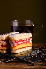 Sweet dessert with black coffee on stone