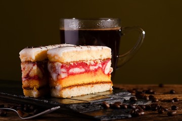 Sweet desserts on black stone with coffee grains