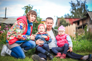 happy young couple with their children have fun at beautiful park outdoor in nature. happiness a family