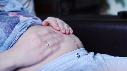 Pregnant woman stroking her belly