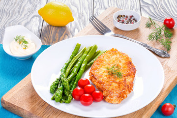 pork chop fried in tempura on a white plate, close-up