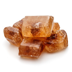Brown caramelized lump cane sugar cube isolated on white backgro