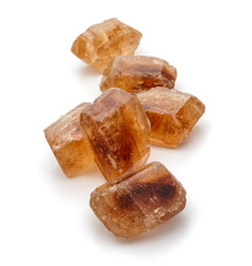 Brown caramelized lump cane sugar cube isolated on white backgro