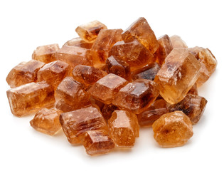 Brown caramelized lump cane sugar cube isolated on white backgro