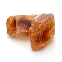Brown caramelized lump cane sugar cube isolated on white backgro