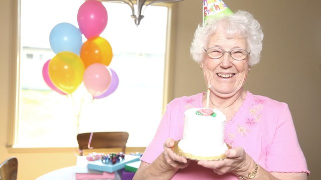 Smiling grandma with cake