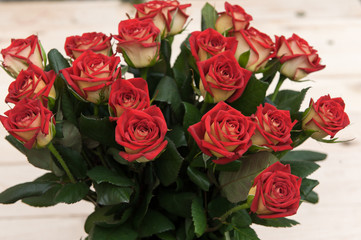 Beautiful red roses on a dark wooden table