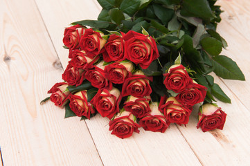 Beautiful red roses on a dark wooden table
