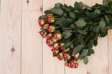Beautiful red roses on a dark wooden table