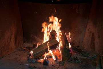 The burning firewood in a fireplace