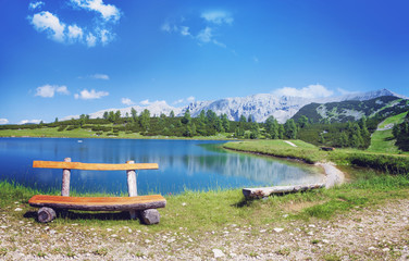 wooden bench beside a wonderful mountain lake