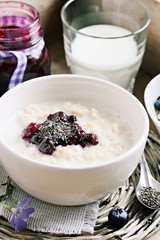 Oatmeal porridge with blueberry jam and chia seeds.Superfoods concept