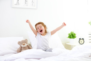 morning awakening child girl in bed