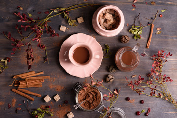 Coffee, hot chocolate or cocoa with cinnamon on rustic wooden background. Top view, copy space.