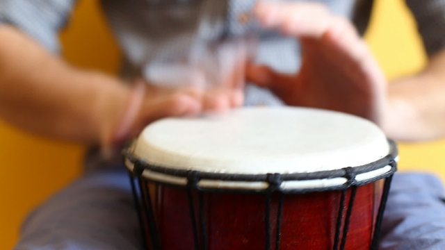 Playing Bongo drum close up HD stock footage. Hand tapping a Bongo drum in close up. 