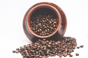 Grains of coffee in a decorative pot