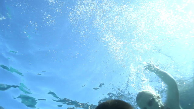 Group of kids swimming underwater