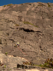 Rock climber climbing a sloping rock wall in Brazil