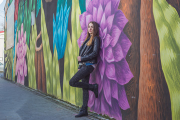 Young woman in urban landscape - graffiti