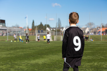 Boy watching youth soccer match