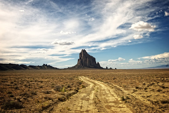 Dirt road on the way to Shiprock a Navajo spirit butte in northwest New Mexico.