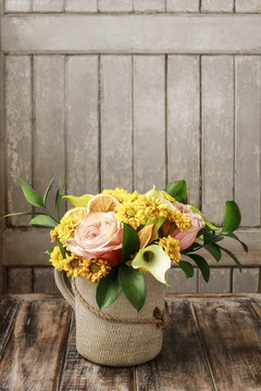 Hipster style summer bouquet with roses, chrysanthemums and call
