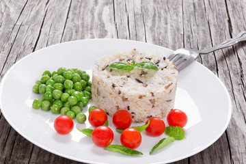 brown and wild rice with cherry tomatoes, green peas