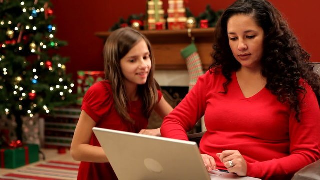 Mother and daughter looking at laptop