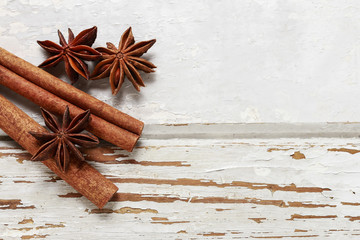 Cinnamon sticks and anise stars on wooden background