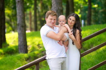 beautiful family with a baby in the park