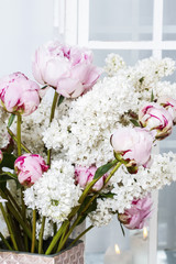 Bouquet of pink peonies and white lilacs