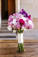 Bouquet with violet orchid, pink roses and freesia flowers