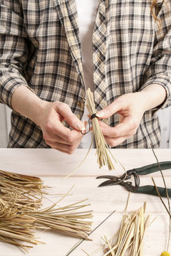 Florist  making decoration with hay