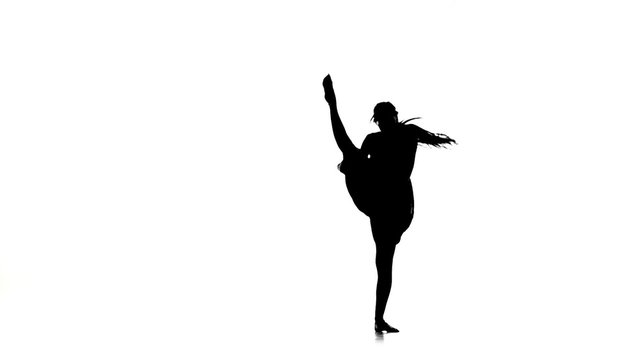 Young woman dancer continue dancing contemporary dance on white, silhouette, slow motion