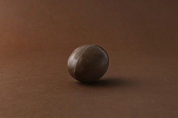 chocolate Easter egg against brown background