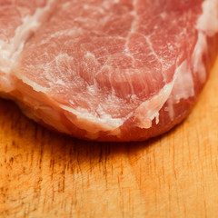 juicy piece of fresh meat on a wooden background, close-up