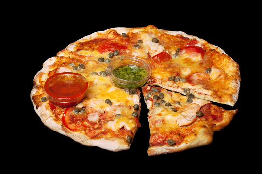 tasty fresh beautiful pizza closeup isolated on black background