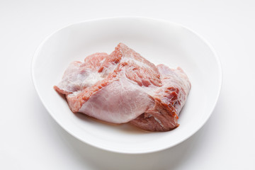 Fresh raw meat in dish, on white background