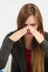 Young woman with painful sinus ache