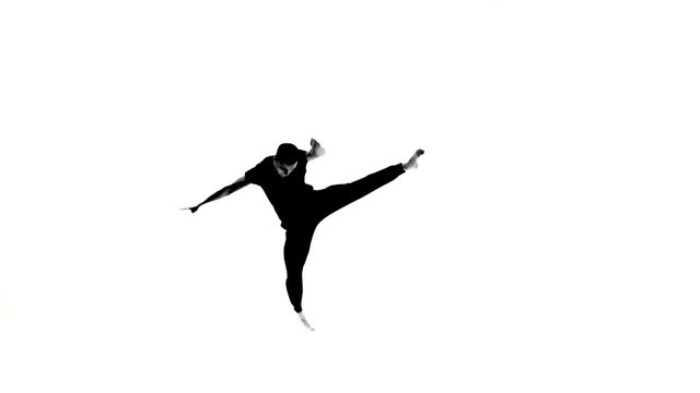 Talanted hip hop dancer showing contemporary movements, white, silhouette, slow motion