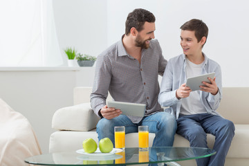 Pretty parent and child are using modern technology