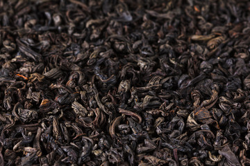 Black tea dry leaves. Macro, background