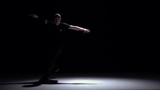 Modern breakdance man jumping on hands dancing, black, shadow, slow motion
