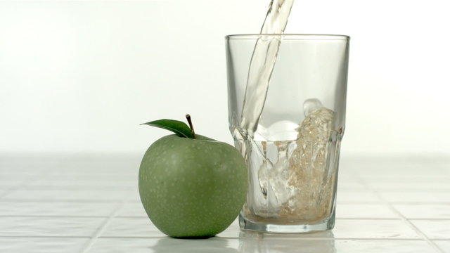 Pouring apple juice, slow motion
