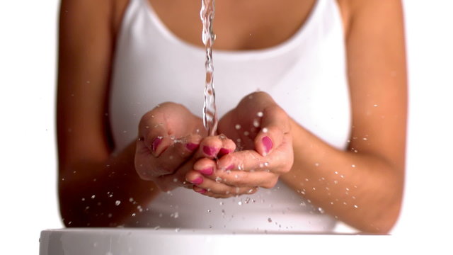Water pouring into womans hands